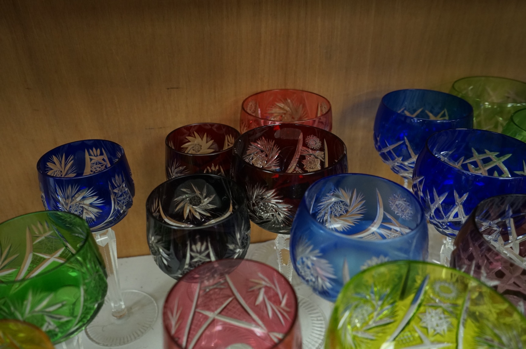 Twenty various Bohemian cut wine glasses, with coloured bowls, 21cm high.